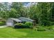 A single story home with mature trees and a lush green lawn offers serene outdoor living at 4766 Jamerson Forest Cir, Marietta, GA 30066