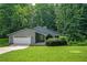 Charming single-story home featuring a well-manicured lawn, mature trees, and an attached two-car garage at 4766 Jamerson Forest Cir, Marietta, GA 30066