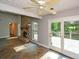 Light-filled living room with stone fireplace and sliding doors to deck at 4766 Jamerson Forest Cir, Marietta, GA 30066