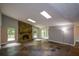 Spacious living room boasts a stone fireplace, skylights, and multi-tone tile flooring at 4766 Jamerson Forest Cir, Marietta, GA 30066