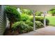View of garden from covered porch with mature landscaping and well-maintained lawn at 4766 Jamerson Forest Cir, Marietta, GA 30066