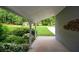 A view from the covered porch reveals a lush lawn and verdant greenery at 4766 Jamerson Forest Cir, Marietta, GA 30066