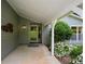 A covered entrance porch featuring a decorative light fixture and a shrubbery-lined walkway at 4766 Jamerson Forest Cir, Marietta, GA 30066