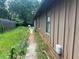 Backyard with grass, fence, and the side of the house at 1130 Monfort Rd, Lawrenceville, GA 30046
