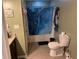 Bathroom featuring a shower with blue curtain, toilet, and vanity with granite top at 1130 Monfort Rd, Lawrenceville, GA 30046