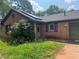 Cozy brick home featuring a charming front porch and solar panels at 1130 Monfort Rd, Lawrenceville, GA 30046