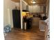 Kitchen with gray cabinets, wood floors, stainless steel refrigerator, and an island at 1130 Monfort Rd, Lawrenceville, GA 30046
