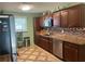 Kitchen showcasing wooden cabinets, stainless steel dishwasher, and light granite countertops at 1130 Monfort Rd, Lawrenceville, GA 30046