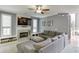 Comfortable living room features a fireplace, large windows, gray sectional sofa, and neutral color scheme at 1641 Rocky Knoll Ln, Dacula, GA 30019