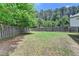 Spacious backyard featuring a well-maintained lawn and a privacy fence, perfect for outdoor activities at 2020 Walking Horse Trl, Cumming, GA 30041