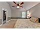 Bright bedroom with a ceiling fan, windows, and a comfortable bed at 2020 Walking Horse Trl, Cumming, GA 30041