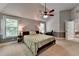 Spacious bedroom with a ceiling fan, windows, and a study area at 2020 Walking Horse Trl, Cumming, GA 30041