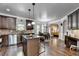 Well-lit kitchen with dark cabinetry, granite countertops, stainless steel appliances, and an island at 2020 Walking Horse Trl, Cumming, GA 30041