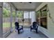 Relaxing screened-in porch with two comfortable chairs, providing a serene space for enjoying the outdoors at 2020 Walking Horse Trl, Cumming, GA 30041