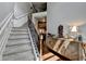 Elegant staircase with carpeted steps and wrought iron railings leading to the upper level at 2020 Walking Horse Trl, Cumming, GA 30041