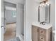 Bathroom with single sink vanity, modern mirror and view into an adjacent bedroom at 3632 Glen Mora Dr, Decatur, GA 30032