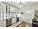 Chic bar area with white cabinets, a mini fridge, and easy access to a stylish powder room at 505 Woodmoore Ct, Sandy Springs, GA 30342