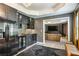 Custom bar area adjacent to media room with black cabinets and modern appliances at 505 Woodmoore Ct, Sandy Springs, GA 30342
