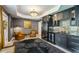 Elegant bar area with dark cabinetry, wine fridge, tile backsplash, and adjacent sitting area at 505 Woodmoore Ct, Sandy Springs, GA 30342