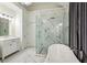 Elegant bathroom with a freestanding tub, glass shower, and marble accents throughout at 505 Woodmoore Ct, Sandy Springs, GA 30342