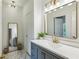 Stylish bathroom with a gray vanity, modern fixtures, and a decorative mirror at 505 Woodmoore Ct, Sandy Springs, GA 30342
