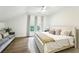 Bright bedroom featuring hardwood floors, neutral tones, and a comfortable seating area at 505 Woodmoore Ct, Sandy Springs, GA 30342