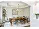 Open dining room with modern chandelier and hardwood flooring at 505 Woodmoore Ct, Sandy Springs, GA 30342