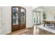 Inviting entryway with glass paneled double doors, opening to a dining area with natural light at 505 Woodmoore Ct, Sandy Springs, GA 30342