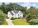 Beautifully landscaped home with a circular driveway and mature trees at 505 Woodmoore Ct, Sandy Springs, GA 30342