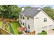 Charming home exterior with a well-manicured yard, patio area, and attached garage at 505 Woodmoore Ct, Sandy Springs, GA 30342