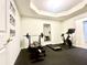 Bright home gym with workout equipment, including a weight bench, treadmill, and stationary bicycle at 505 Woodmoore Ct, Sandy Springs, GA 30342