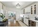 Bright white kitchen featuring stainless steel appliances, quartz countertops, and hardwood flooring at 505 Woodmoore Ct, Sandy Springs, GA 30342
