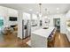 Bright, open kitchen featuring a large island with seating and stainless steel appliances at 505 Woodmoore Ct, Sandy Springs, GA 30342