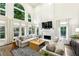Spacious living room with large arched windows, custom draperies, and a fireplace at 505 Woodmoore Ct, Sandy Springs, GA 30342