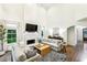 Open living room with fireplace, high ceilings, and hardwood flooring at 505 Woodmoore Ct, Sandy Springs, GA 30342