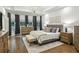 Main bedroom features hardwood flooring, a tray ceiling, and modern decor at 505 Woodmoore Ct, Sandy Springs, GA 30342