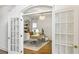 Office with custom built-in shelves, a modern desk, and a comfortable place to work at 505 Woodmoore Ct, Sandy Springs, GA 30342