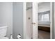 Bathroom featuring neutral walls, shower, and toilet with a peek into the bedroom at 6962 Gallant Circle Southeast Se Cir # 24, Mableton, GA 30126