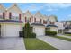 Charming townhouses with attached garages, red shutters, and manicured lawns offer comfortable and stylish living at 6962 Gallant Circle Southeast Se Cir # 24, Mableton, GA 30126