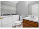 Functional laundry room with washer, dryer, wire shelving, and adjacent half bath at 6962 Gallant Circle Southeast Se Cir # 24, Mableton, GA 30126