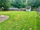 Large backyard features a patio and white storage shed in a fully fenced yard at 1468 Spruce Se Dr, Smyrna, GA 30080