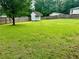 Spacious backyard with lush grass and a charming shed at 1468 Spruce Se Dr, Smyrna, GA 30080