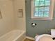 Standard bathroom with tub and simple decor features natural light from the window at 1468 Spruce Se Dr, Smyrna, GA 30080