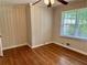 Bedroom features hardwood floors, panelled walls, and a bright window at 1468 Spruce Se Dr, Smyrna, GA 30080