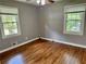 Bedroom featuring hardwood floors, neutral colored walls, and natural light from two windows at 1468 Spruce Se Dr, Smyrna, GA 30080