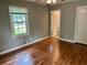 Bedroom boasts pristine hardwood floors, a bright window, and a nearby bathroom at 1468 Spruce Se Dr, Smyrna, GA 30080