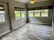 Enclosed sunroom with neutral walls, vinyl flooring, and bright windows at 1468 Spruce Se Dr, Smyrna, GA 30080
