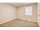 The bedroom features soft carpeting and a window for natural light, creating a cozy atmosphere at 1101 White Oak Ave, Atlanta, GA 30310