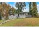 View of a home, surrounded by mature trees and lush greenery, showcasing its peaceful setting at 1101 White Oak Ave, Atlanta, GA 30310