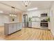 Modern kitchen with stainless steel appliances, granite counters, island and pendant lighting at 1101 White Oak Ave, Atlanta, GA 30310